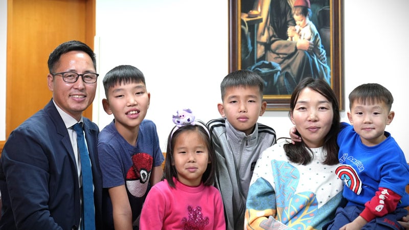 Nasanbold Sahkbaatar family photo in a church meetinghouse
