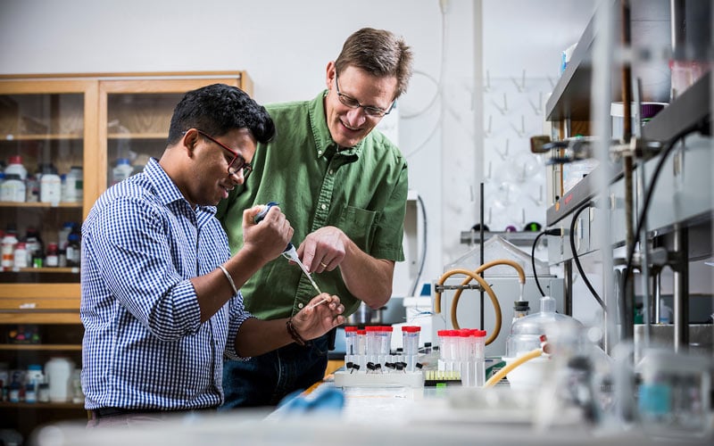 Professor Adam Woolley and student Mukul Sonker working in a lab