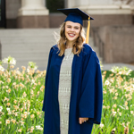 Female BYU graduate posing for a photo outdoors.