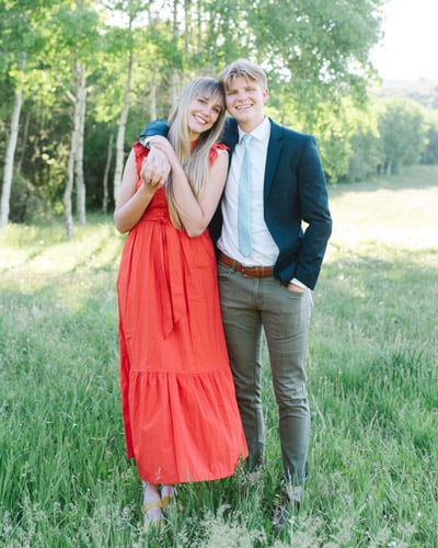 Davis Johnson and his wife smiling outdoors in front of trees