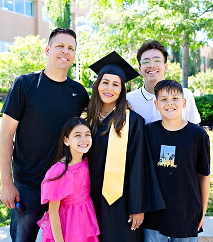 A BYU-Idaho graduate posing for a photo with her family